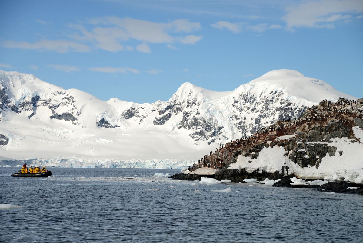 14A Penguin Colony On The Cuverville Island Coast With Arctowski Peninsula Mountains Beyond From Zodiac On Quark Expeditions Antarctica Cruise